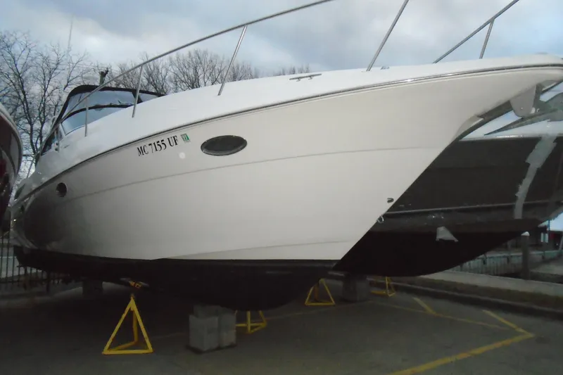 The Image of 2003 Cruisers Yachts 3470 Express boat on stands, side view, outdoors. - 0