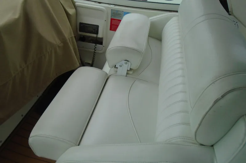 Slide: The Image of 2003 Cruisers Yachts 3470 Express interior with white leather seating and control panel. - 19