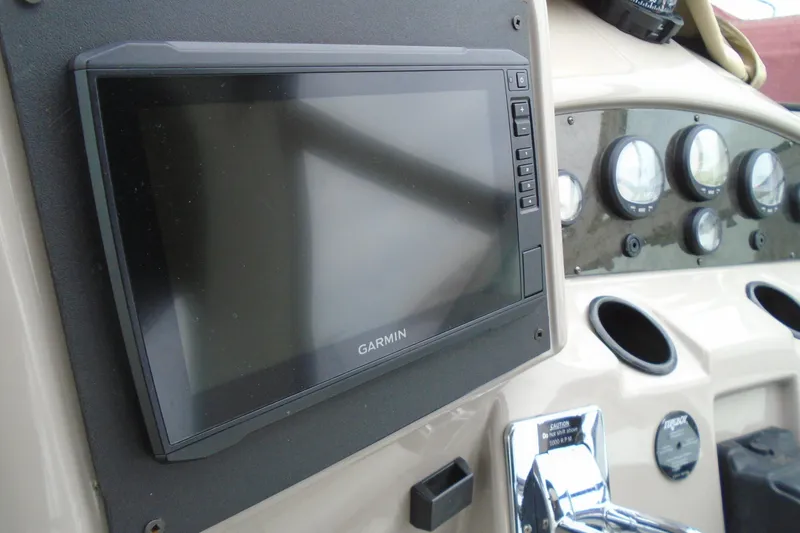 Slide: The Image of Garmin display and gauges on 2003 Cruisers Yachts 3470 Express dashboard. - 23