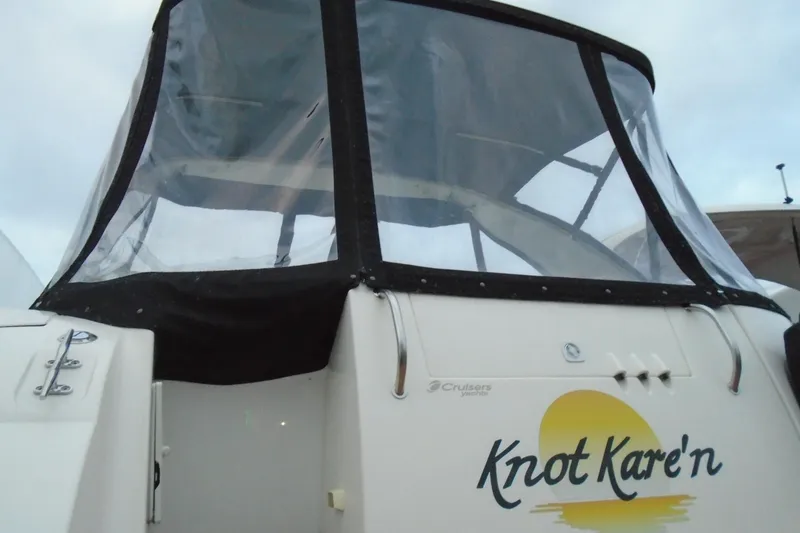 Slide: The Image of 2003 Cruisers Yachts 3470 Express with custom "Knot Kare'n" name on the stern. - 3