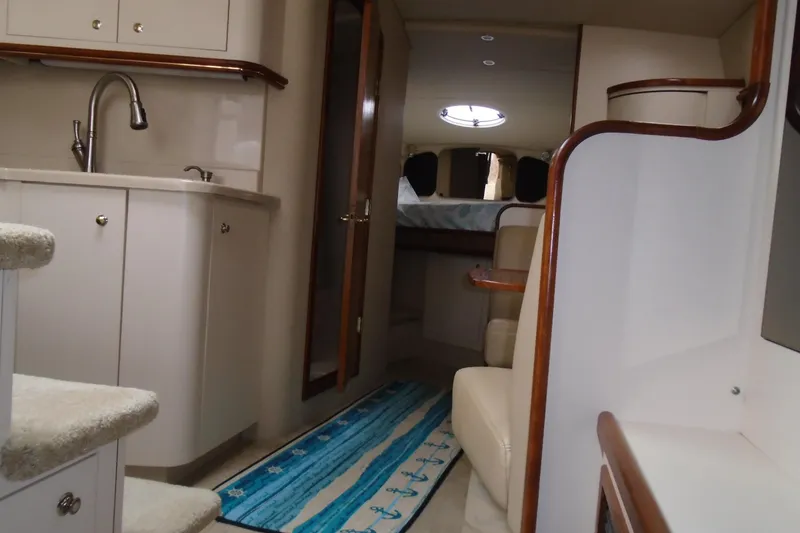 Slide: The Image of 2003 Cruisers Yachts 3470 Express interior with kitchenette and seating area. - 32