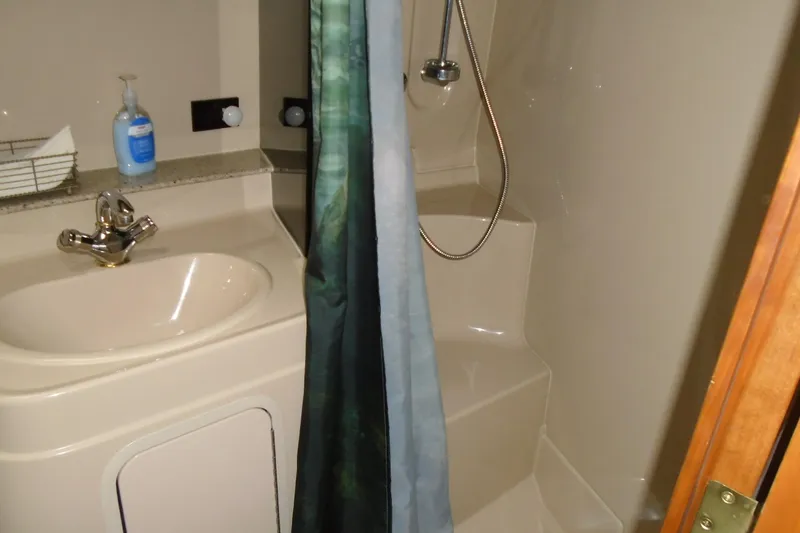 Slide: The Image of 2003 Cruisers Yachts 3470 Express bathroom with sink, shower, and curtain. - 37