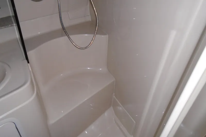 Slide: The Image of 2003 Cruisers Yachts 3470 Express bathroom with shower and seating area. - 38
