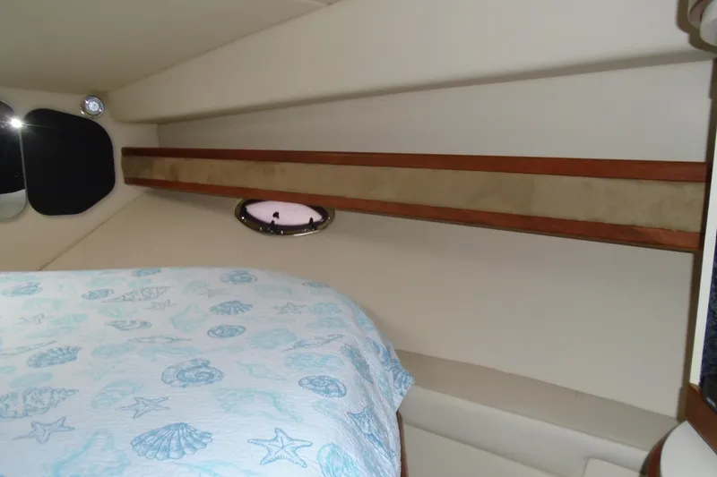 Slide: The Image of Interior cabin of 2003 Cruisers Yachts 3470 Express with nautical-themed bedding. - 40