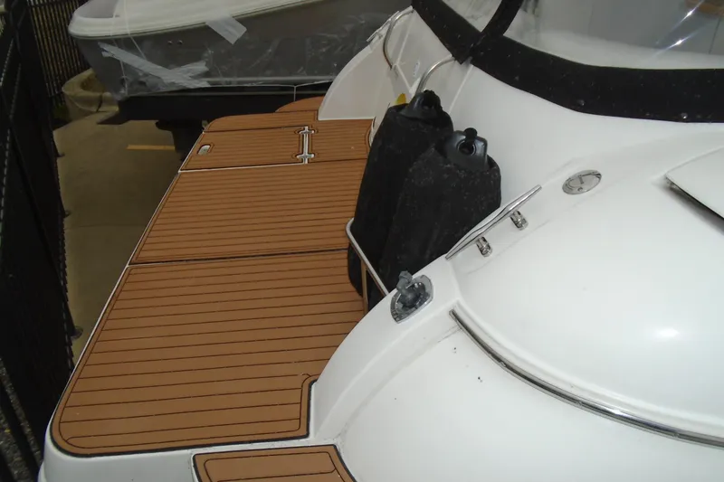 Slide: The Image of 2003 Cruisers Yachts 3470 Express with teak swim platform and black fenders. - 8
