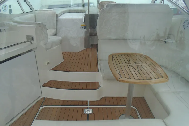 Slide: The Image of 2003 Cruisers Yachts 3470 Express interior with wooden flooring and seating area. - 9