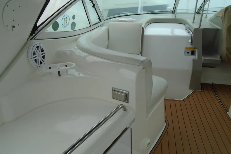 Slide: The Image of 2003 Cruisers Yachts 3470 Express interior with white seating and wood flooring. - 10