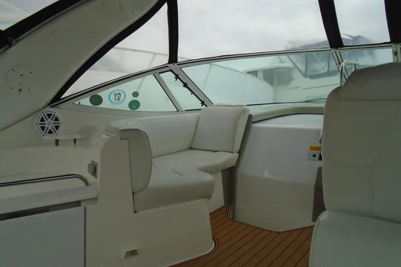 Slide: The Image of 2003 Cruisers Yachts 3470 Express interior with white seating and wood flooring. - 15