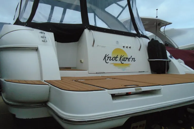 Slide: The Image of 2003 Cruisers Yachts 3470 Express with teak deck and custom name "Knot Kare'n". - 2