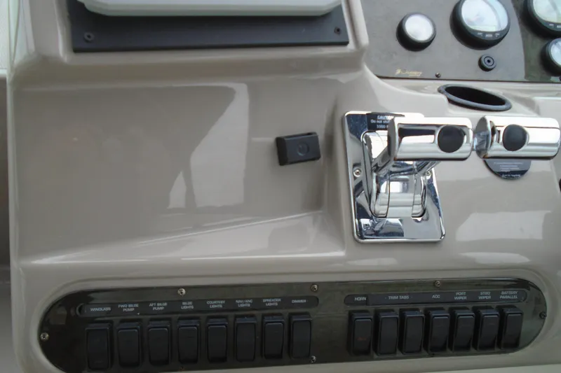 Slide: The Image of Control panel of 2003 Cruisers Yachts 3470 Express with switches and throttle levers. - 21