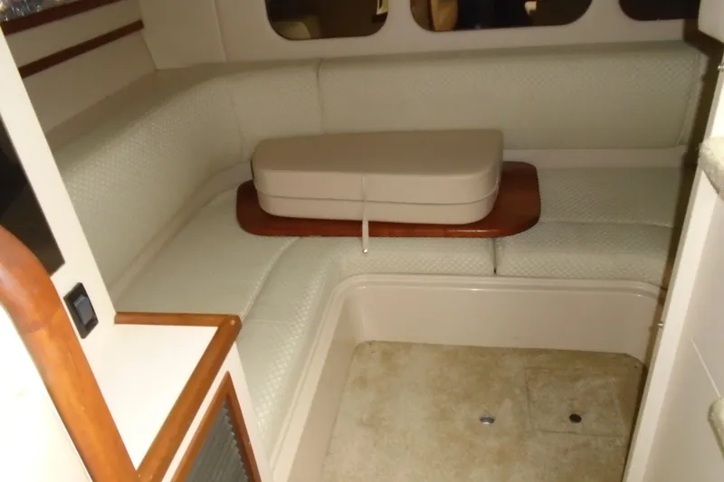 Slide: The Image of 2003 Cruisers Yachts 3470 Express interior with beige seating and wooden accents. - 29