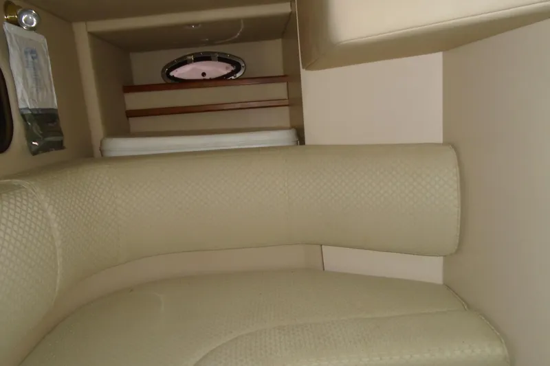 Slide: The Image of 2003 Cruisers Yachts 3470 Express interior with beige seating and small window. - 31