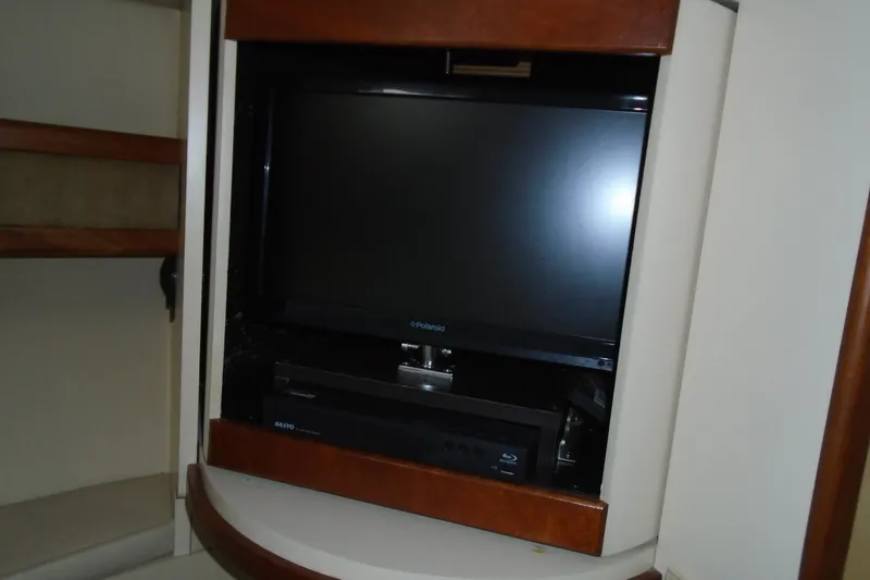 Slide: The Image of Entertainment system in 2003 Cruisers Yachts 3470 Express with TV and Blu-ray player. - 41