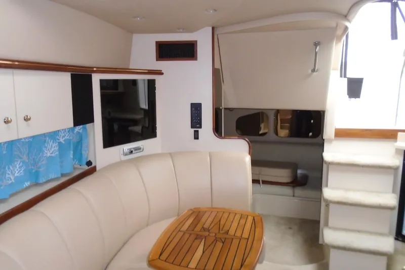 Slide: The Image of Interior of 2003 Cruisers Yachts 3470 Express with seating, table, and stairs. - 42