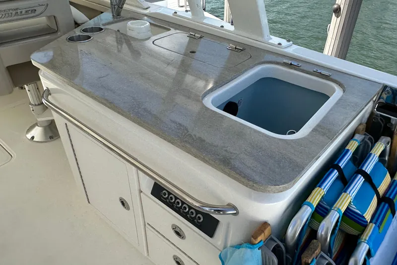 Slide: The Image of Boston Whaler 320 Vantage 2018 boat interior with sink and storage compartments. - 11