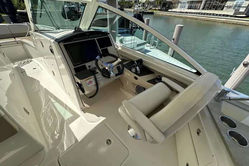 Slide: The Image of 2018 Boston Whaler 320 Vantage boat cockpit with steering wheel and control panel. - 13