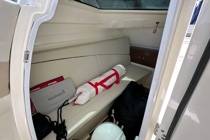 Slide: The Image of Interior cabin of 2018 Boston Whaler 320 Vantage with seating and equipment. - 16