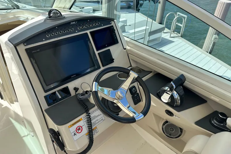 Slide: The Image of Cockpit of 2018 Boston Whaler 320 Vantage with steering wheel and navigation screens. - 4