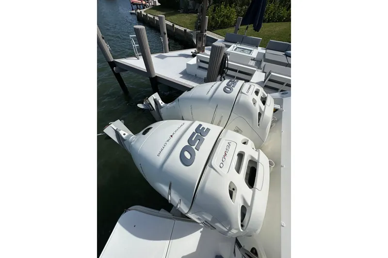 Slide: The Image of Boston Whaler 320 Vantage 2018 with twin 350 Verado engines docked by the water. - 7