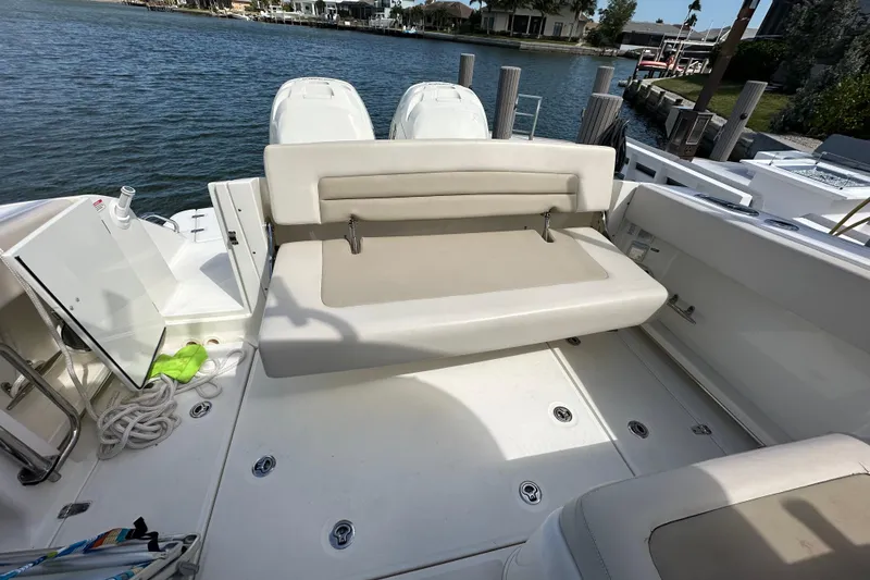 Slide: The Image of 2018 Boston Whaler 320 Vantage boat interior with seating and water view. - 8