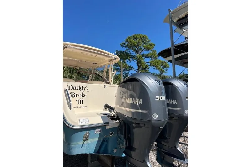 Slide: The Image of 2020 Grady-White Freedom 307 boat with dual engines, docked at a marina. - 12