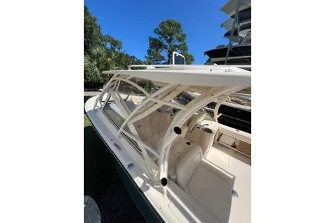 Slide: The Image of 2020 Grady-White Freedom 307 boat with sleek design and spacious seating under clear blue sky. - 14