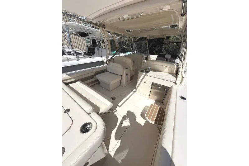 Slide: The Image of 2020 Grady-White Freedom 307 boat interior with beige seating and modern amenities. - 15