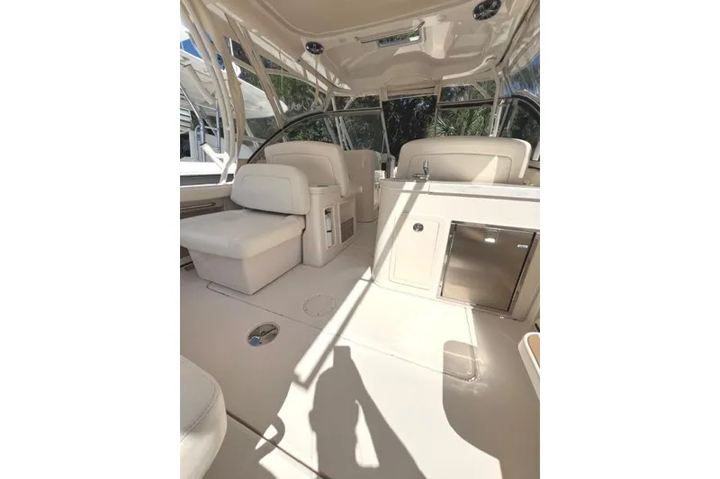 Slide: The Image of 2020 Grady-White Freedom 307 boat interior with seating and kitchenette. - 20