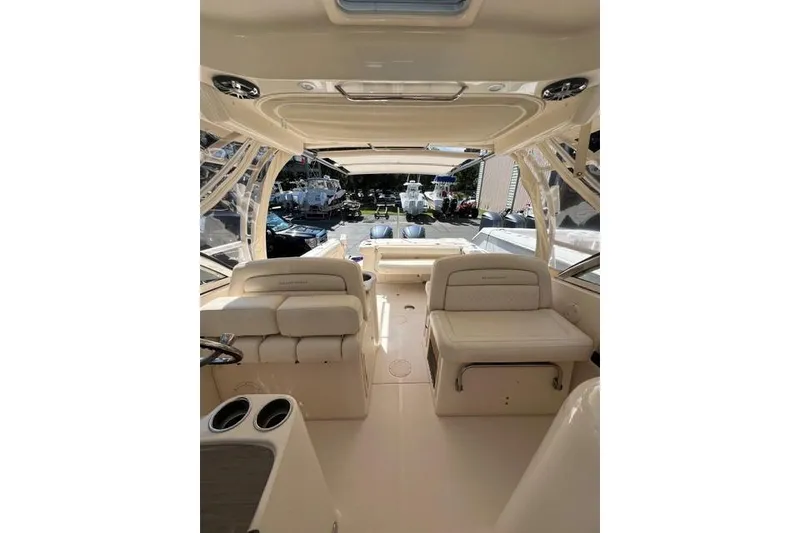 Slide: The Image of 2020 Grady-White Freedom 307 boat, blue hull, parked on land, sunny day. - 3