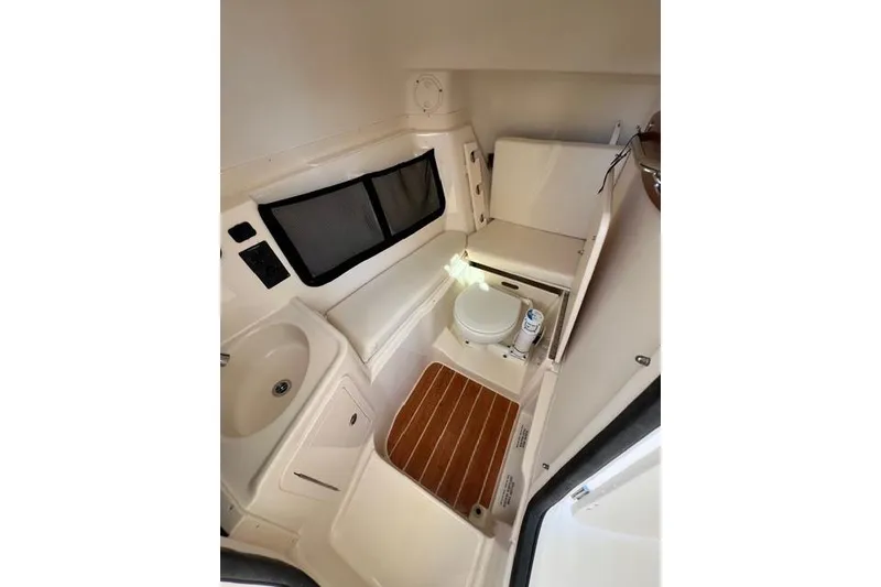 Slide: The Image of 2020 Grady-White Freedom 307 boat exterior with logo, blue hull, sunny day. - 8