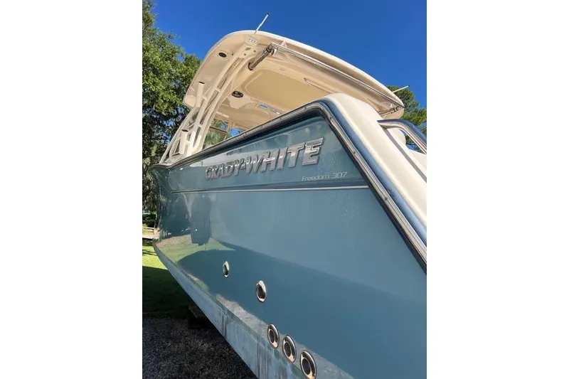 Slide: The Image of 2020 Grady-White Freedom 307 boat on display under clear blue sky. - 9