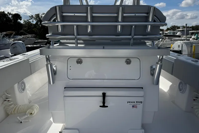 Slide: The Image of 2026 Contender 35 ST boat interior with storage and rod holders, docked under a blue sky. - 11