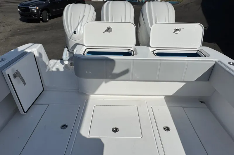 Slide: The Image of 2026 Contender 35 ST boat deck with storage compartments and outboard engines. - 21