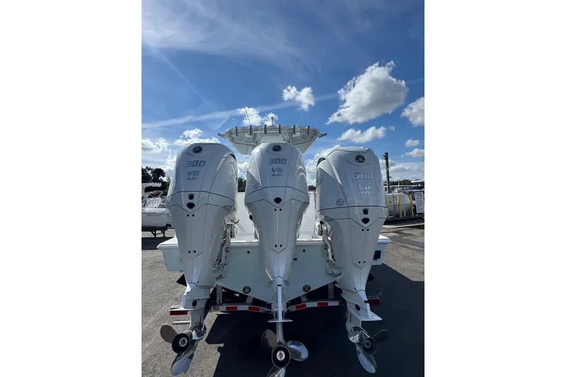 Slide: The Image of 2026 Contender 35 ST boat with triple 300 V6 outboard engines under a clear sky. - 3