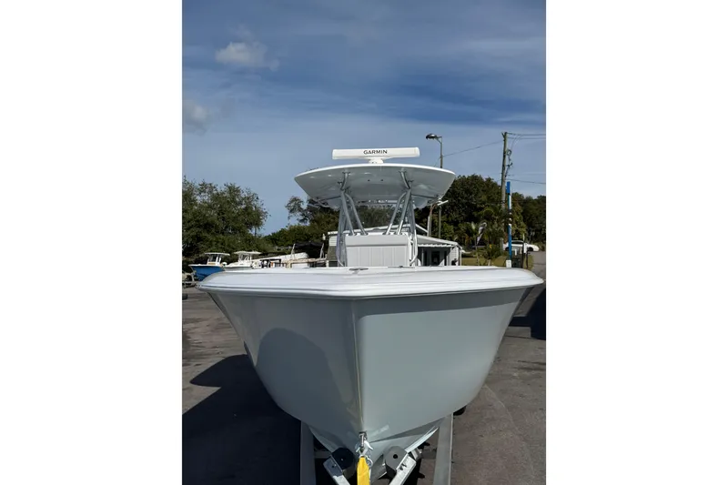 Slide: The Image of 2026 Contender 35 ST boat, front view, parked outdoors under clear sky. - 4