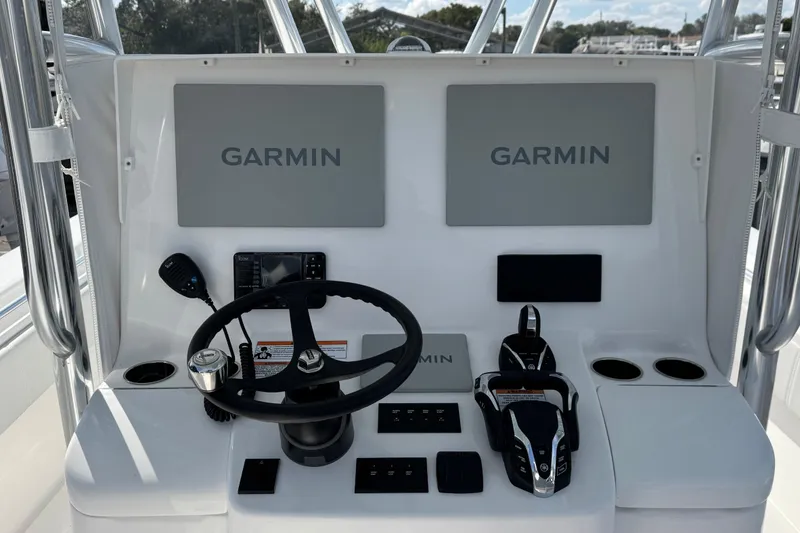 Slide: The Image of 2026 Contender 35 ST boat dashboard with Garmin navigation displays and controls. - 7