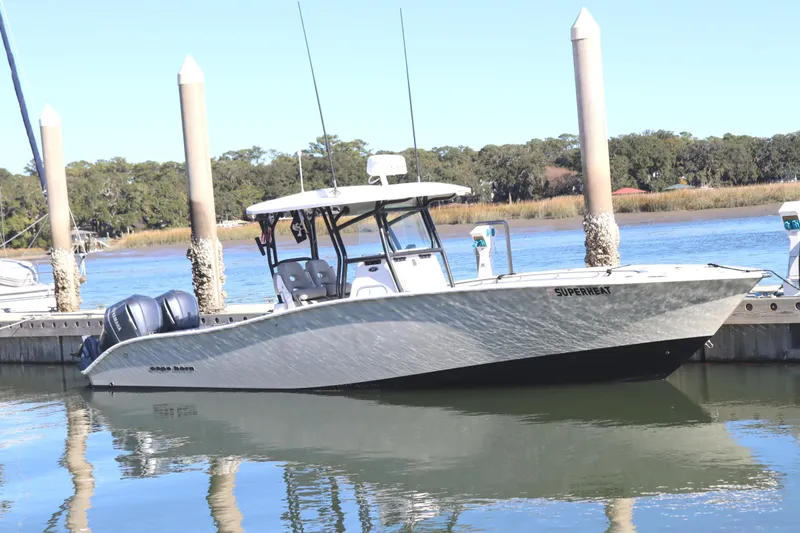 Slide: The Image of 2021 Cape Horn 31 T boat docked on calm water with twin engines. - 2