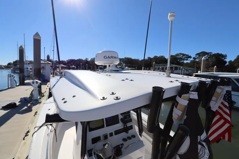Slide: The Image of 2021 Cape Horn 31 T boat docked, featuring Garmin equipment and rod holders. - 32