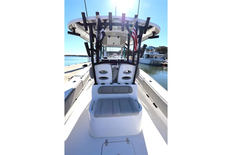 Slide: The Image of 2021 Cape Horn 31 T boat interior with seating and rod holders, docked in marina. - 33