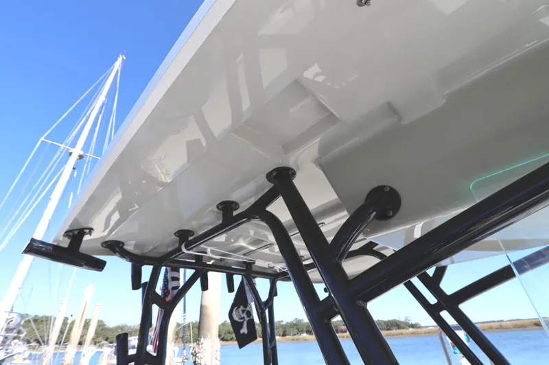 Slide: The Image of 2021 Cape Horn 31 T boat with sturdy T-top and rod holders, docked by the water. - 47