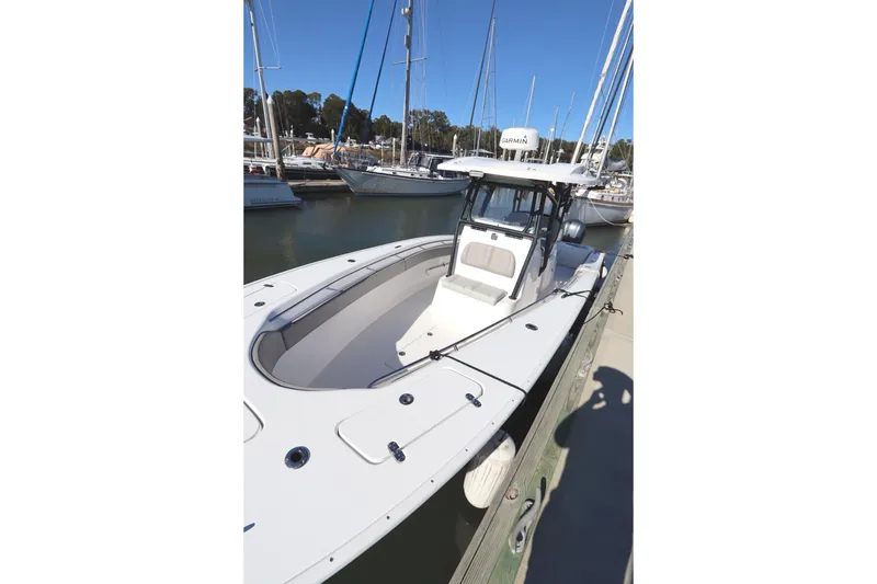 Slide: The Image of 2021 Cape Horn 31 T boat docked at marina, clear sky background. - 9
