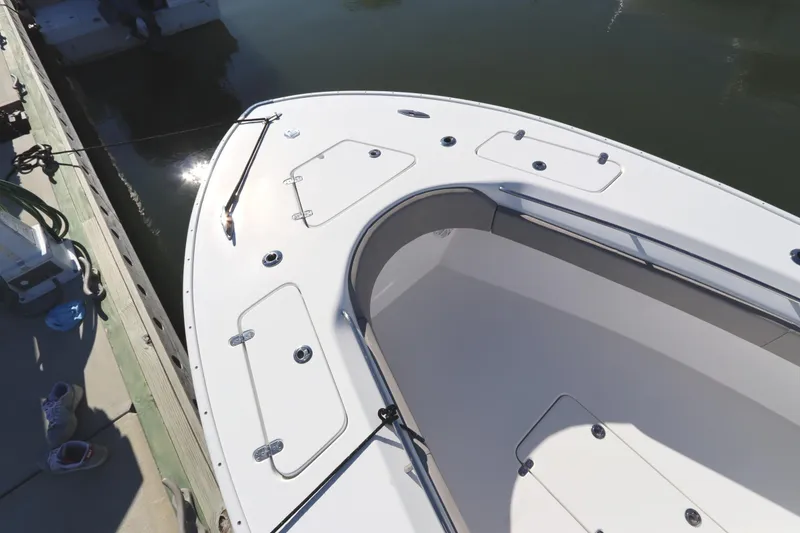 Slide: The Image of 2021 Cape Horn 31 T boat docked, showcasing sleek design and storage compartments. - 10