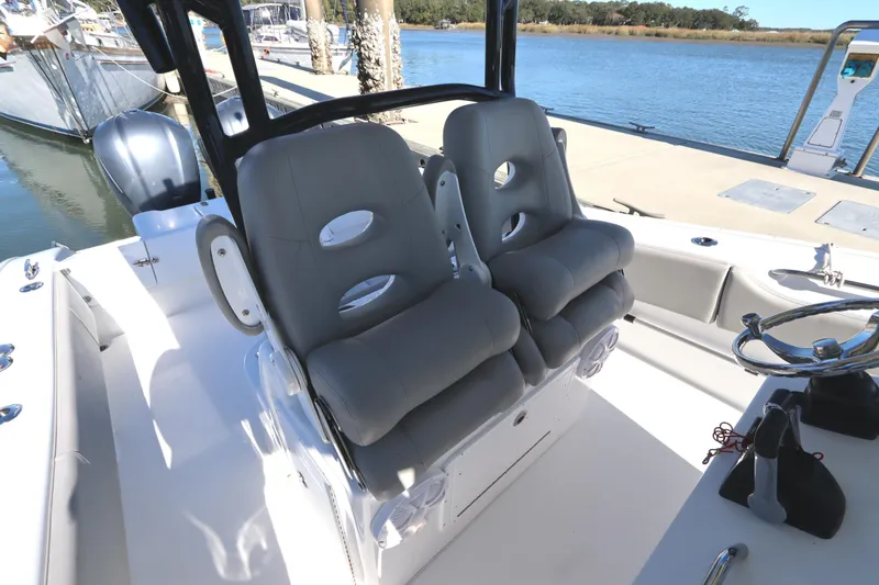 Slide: The Image of 2021 Cape Horn 31 T boat interior with dual cushioned seats and steering wheel. - 19