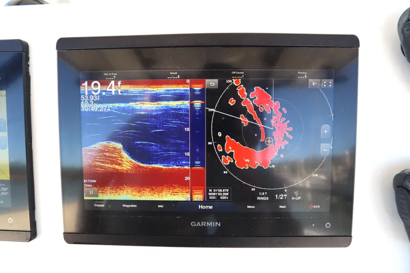 Slide: The Image of Garmin marine display on 2021 Cape Horn 31 T, showing sonar and radar data. - 24