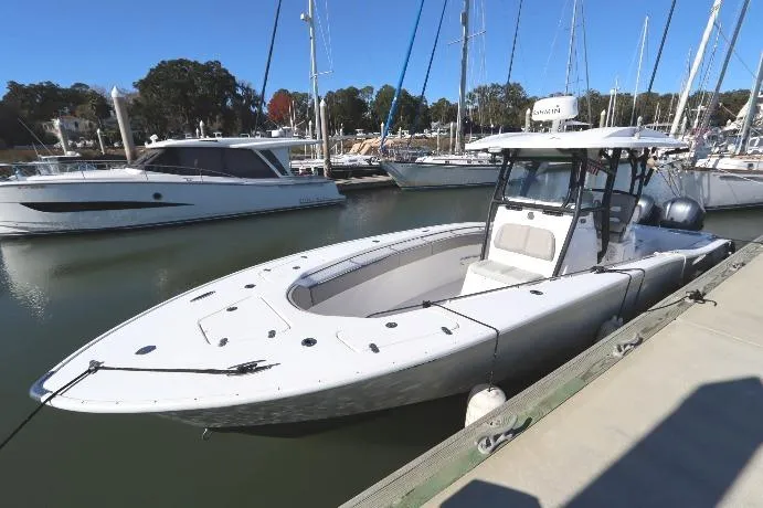 Slide: The Image of 2021 Cape Horn 31 T boat docked in a marina with sailboats in the background. - 3