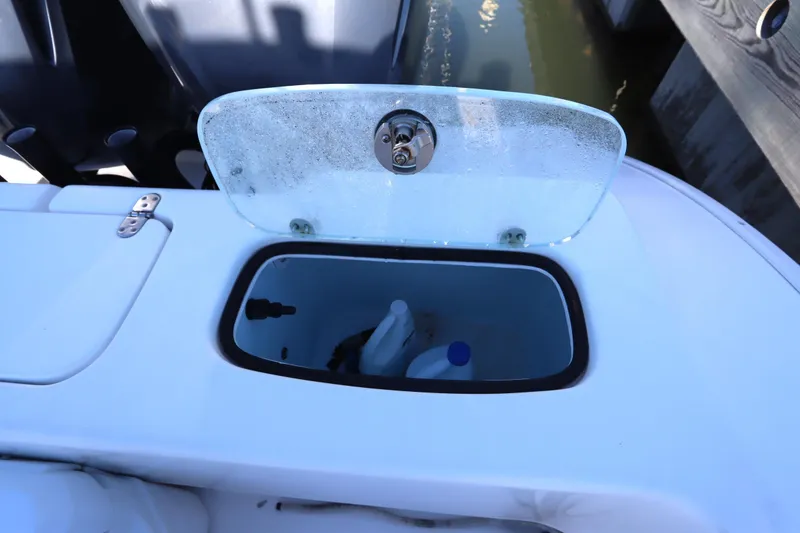 Slide: The Image of Open storage compartment on 2021 Cape Horn 31 T boat, containing cleaning supplies. - 36