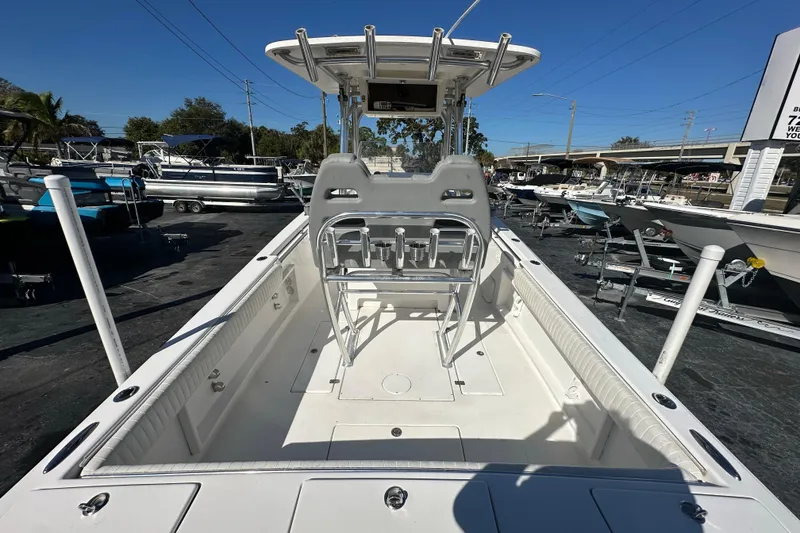 Slide: The Image of 2005 Topaz 24 Silverhawk boat interior with seating and console, displayed outdoors. - 18