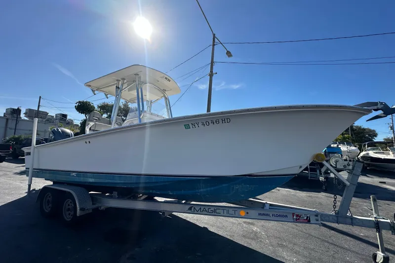 Slide: The Image of 2005 Topaz 24 Silverhawk boat on trailer under bright sun. - 5