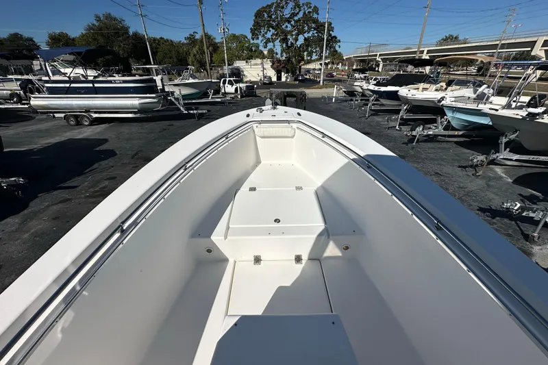 Slide: The Image of 2005 Topaz 24 Silverhawk boat on display at a marina with other vessels. - 8