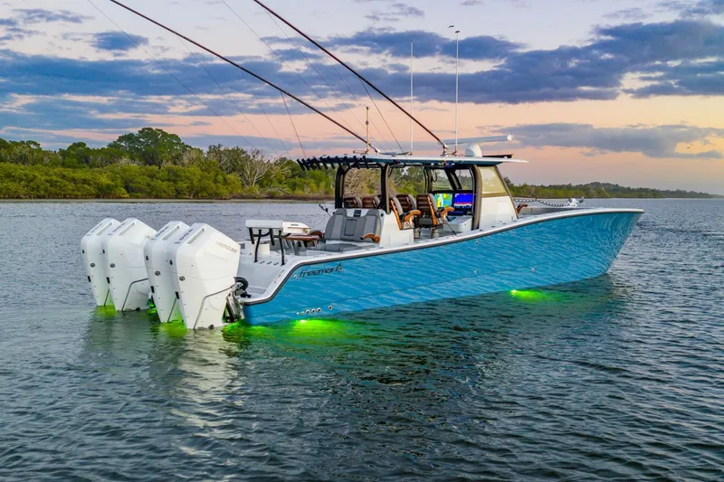The Image of 2025 Freeman 43 boat cruising on water at sunset with passengers onboard. - 0